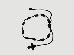 Black adjustable knotted decade cord bracelet with woven cross