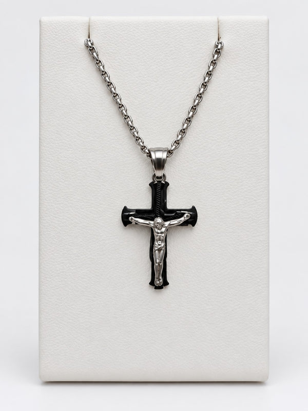 A black flared crucifix with a silver-tone figure of Jesus, silver-tone bail and silver-tone chain.