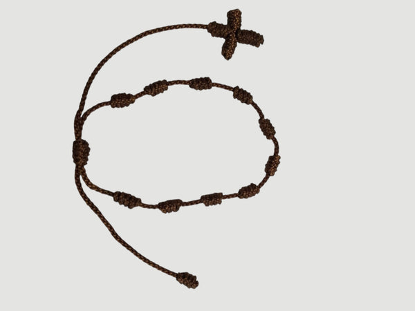 Brown adjustable knotted decade cord bracelet with woven cross