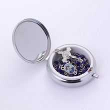 Blue crystal Dr. José Gregorio Hernández rosary inside open metal keepsake box