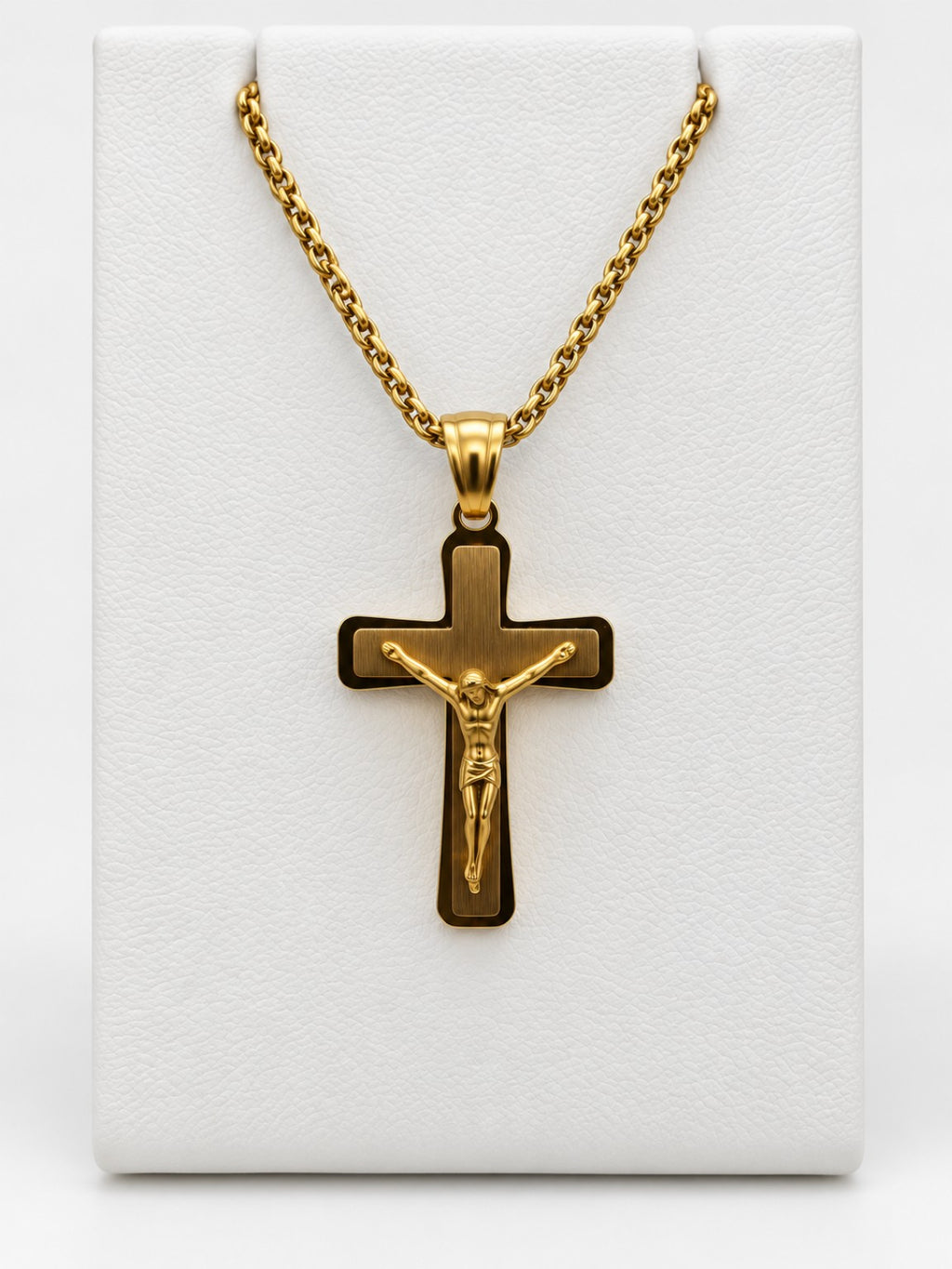 A gold-tone crucifix with a brushed-look center, polished border and a raised figure of Jesus.