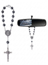 Hematite Saint Benedict auto rosary hanging from a car rearview mirror