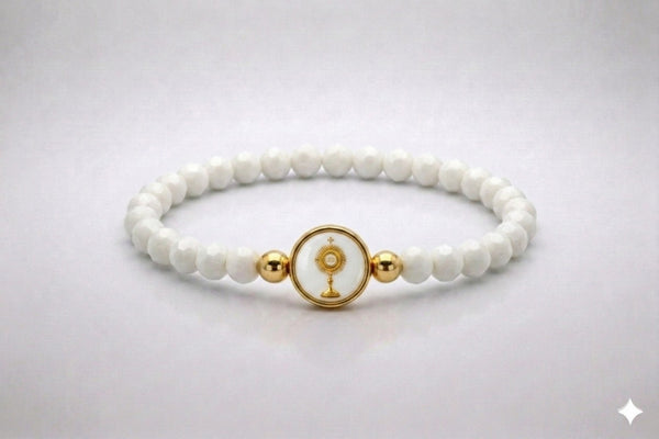 Holy Eucharist white crystal elastic bracelet with gold-tone centerpiece, front view