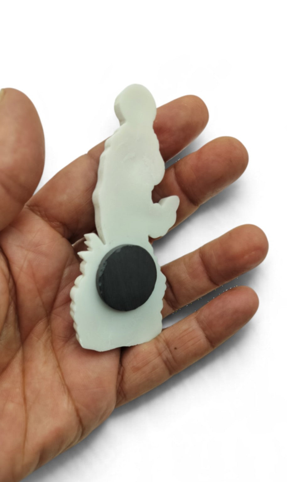 Back of Virgin Mary refrigerator magnet showing magnet