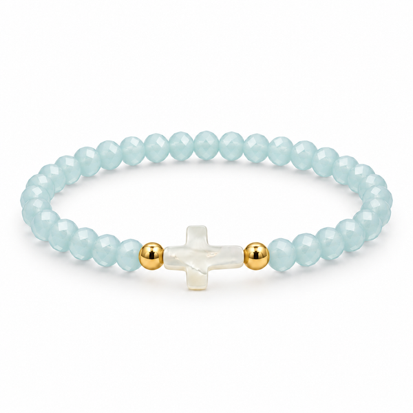 pale aqua baby blue crystal stretch bracelet with mother-of-pearl cross and two gold-tone spacers on white