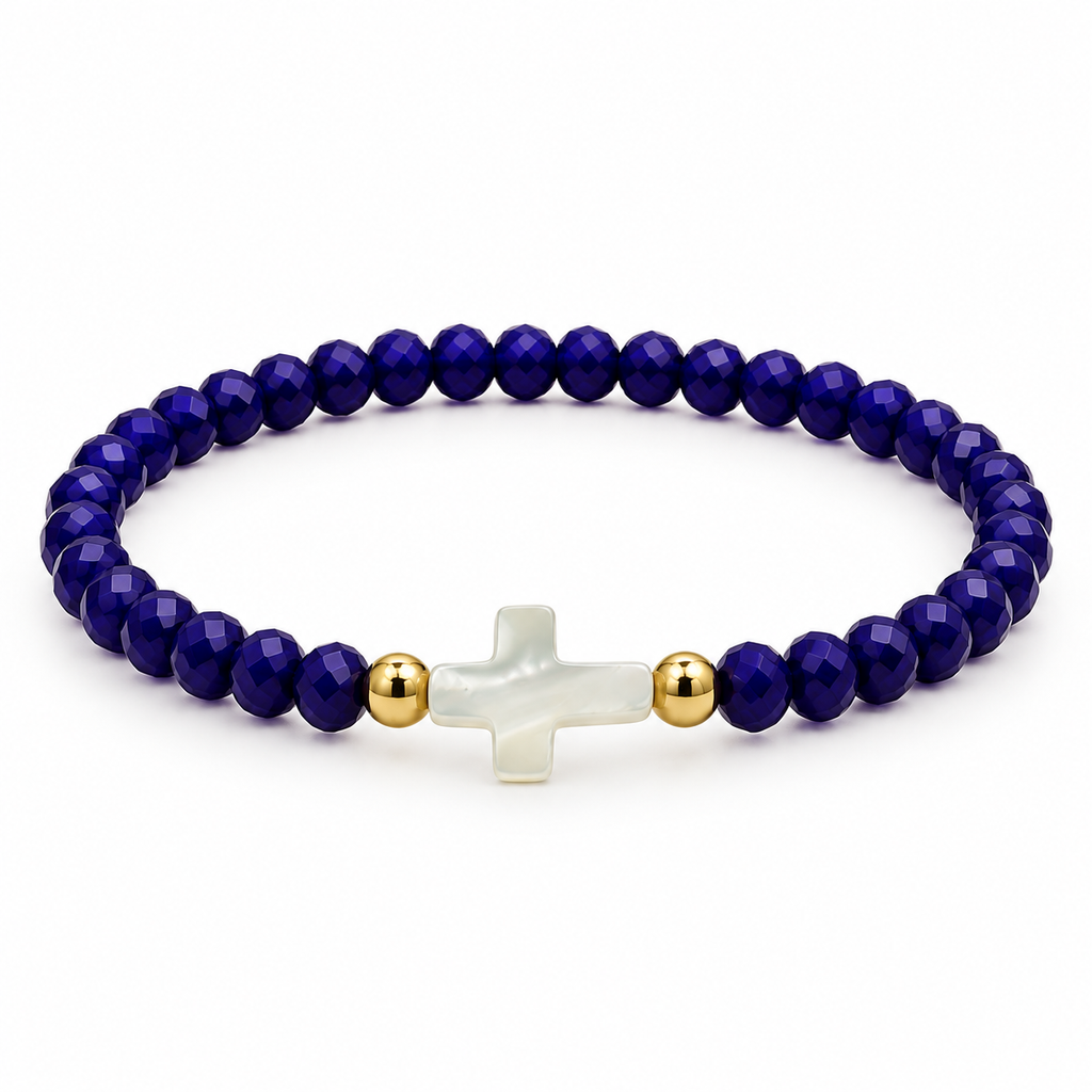 dark blue stretch bracelet with mother-of-pearl cross and two gold-tone spacers on white