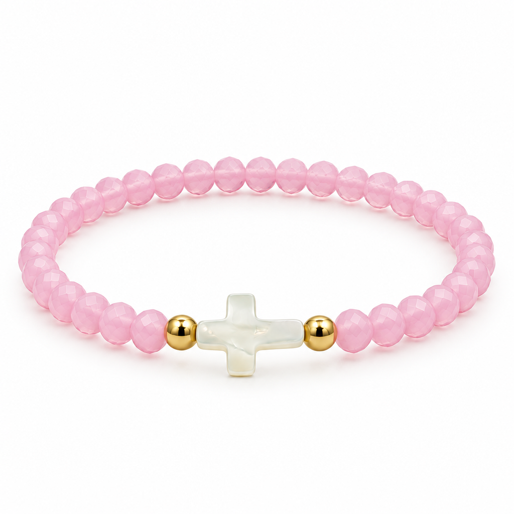pale pink stretch bracelet with mother-of-pearl cross and two gold-tone spacers on white