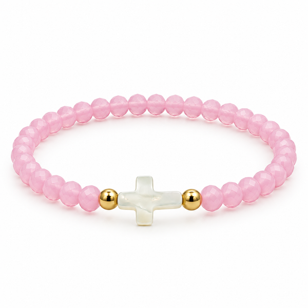 pale pink stretch bracelet with mother-of-pearl cross and two gold-tone spacers on white