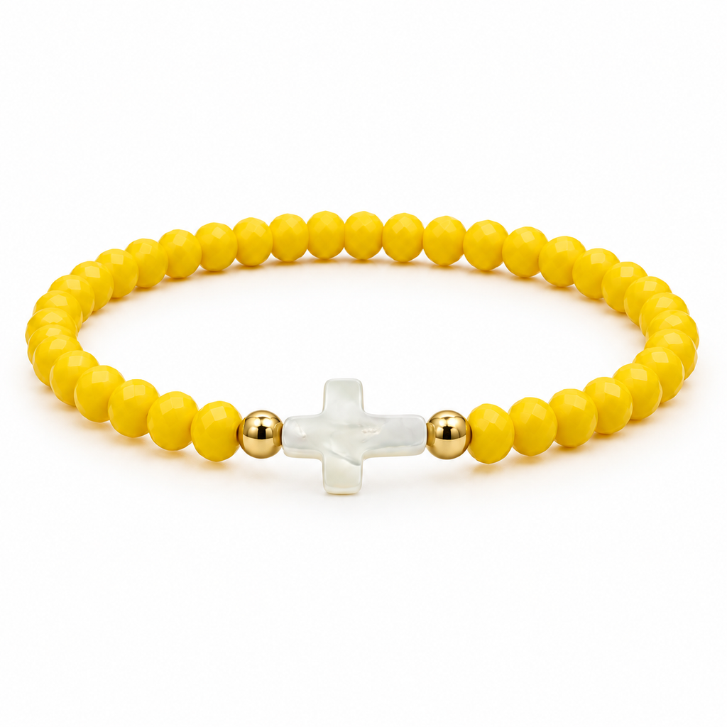 yellow stretch bracelet with mother-of-pearl cross and two gold-tone spacers on white