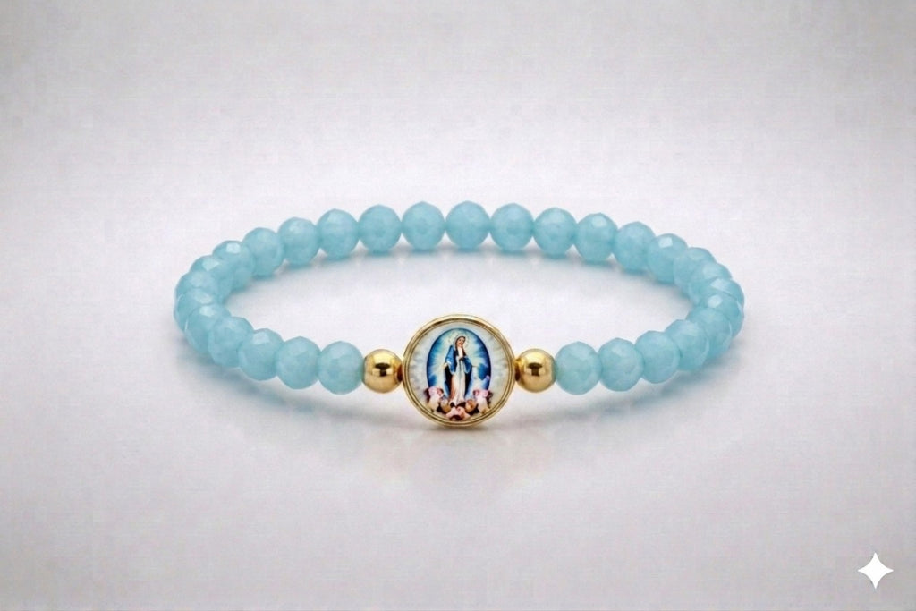 Our Lady of Grace light blue crystal elastic bracelet with gold-tone centerpiece, front view