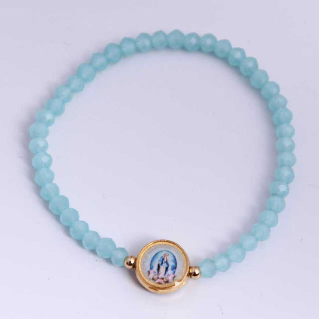 Virgen Milagrosa: pulsera elástica de cristal azul claro, vista superior