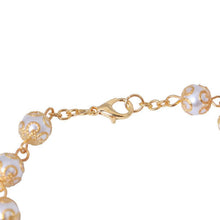 Gold-tone lobster clasp and pearl-look bead detail