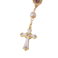 White and gold-tone decorative cross close-up