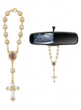 Our Lady of Guadalupe car rosary hanging from a rearview mirror