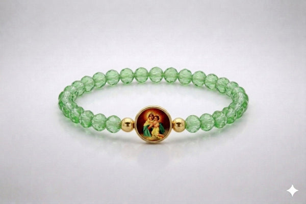 Our Lady of Schoenstatt light green crystal elastic bracelet with gold-tone accents, front view