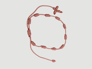 Pink adjustable knotted decade cord bracelet with woven cross