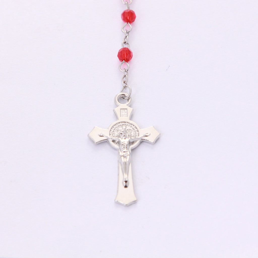 Front of Saint Benedict crucifix on red crystal devotional rosary