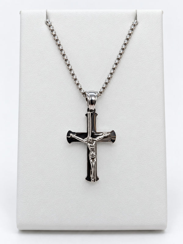 A polished silver-tone crucifix with flared cross ends and a raised figure of Jesus.
