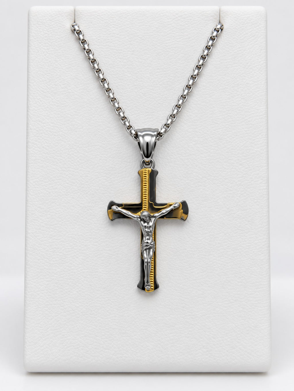 A flared crucifix with gold-tone accent details, a silver-tone figure of Jesus and a silver-tone chain.