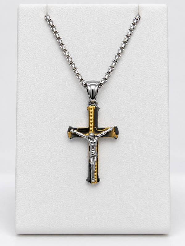 A flared crucifix with gold-tone accent details, a silver-tone figure of Jesus and a silver-tone chain.